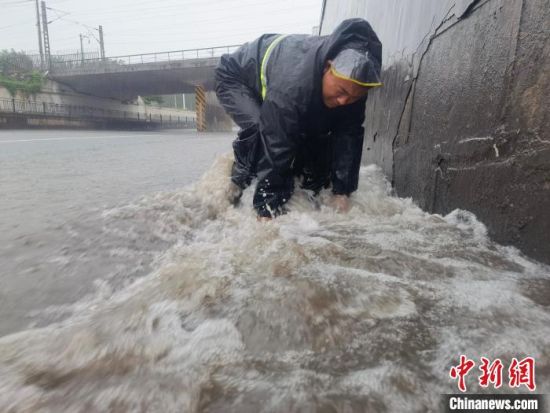 图为邯郸冀南新区防汛一线应急人员冒雨排除险情。　钱磊 摄