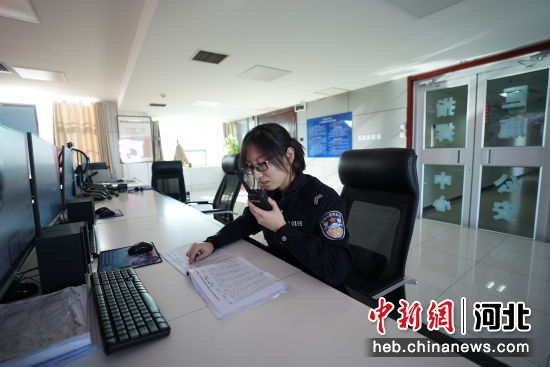 巨鹿县公安局110指挥中心接警员通过对讲机协调工作。薛镱乐 摄