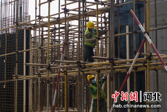 在河北省唐山市�S南�^陶瓷�a�I�@�目施工�F��，工人正在�M行主�w�筋搭建。 崔光 �z