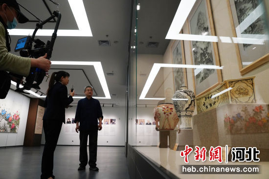 图为磁州窑匠人在峰峰博物馆磁州窑展厅进行讲解。 李栋 摄